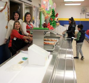 Staff serving food to our families